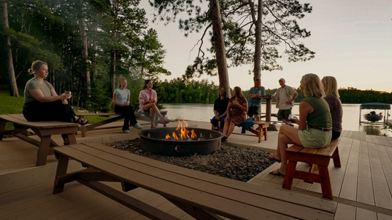 Group of people sitting around a fire pit