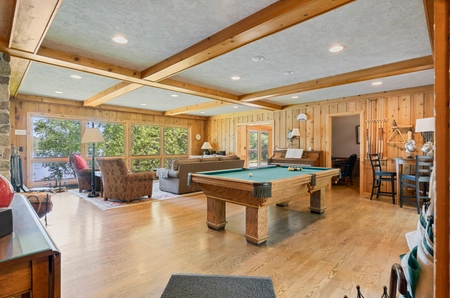 A community room at Birchview with several options for seating and a pool table