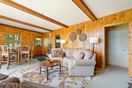 Garden cottage living room with a cream-colored couch and high-top table with four chairs
