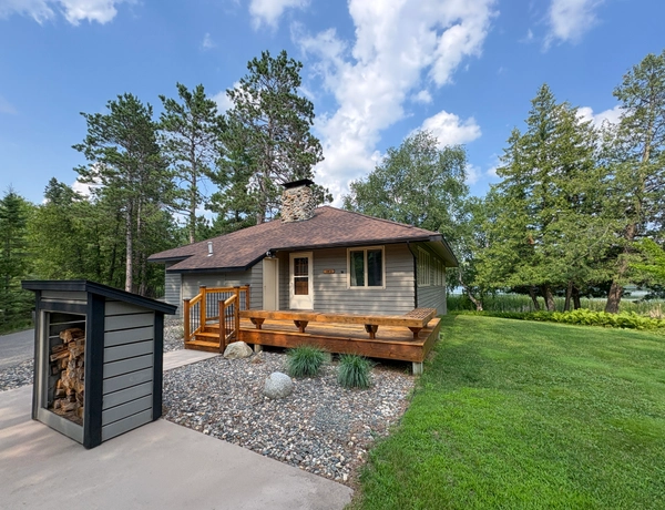 South cottage surrounded by trees and the lake