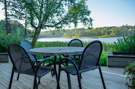 A table of chairs overlooking the lake
