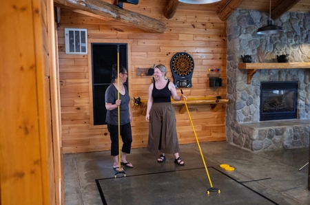 Two women playing shuffleboard